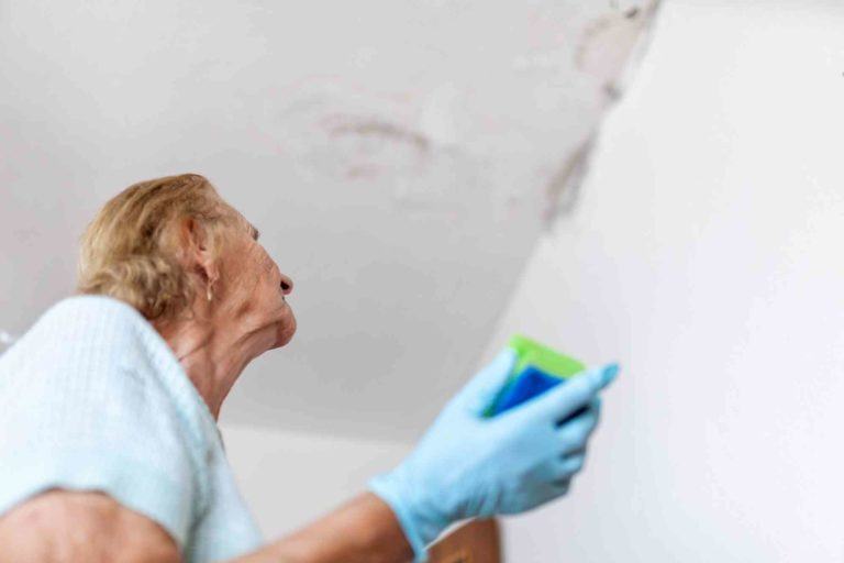 Frau steht unterm Plafond der tropft